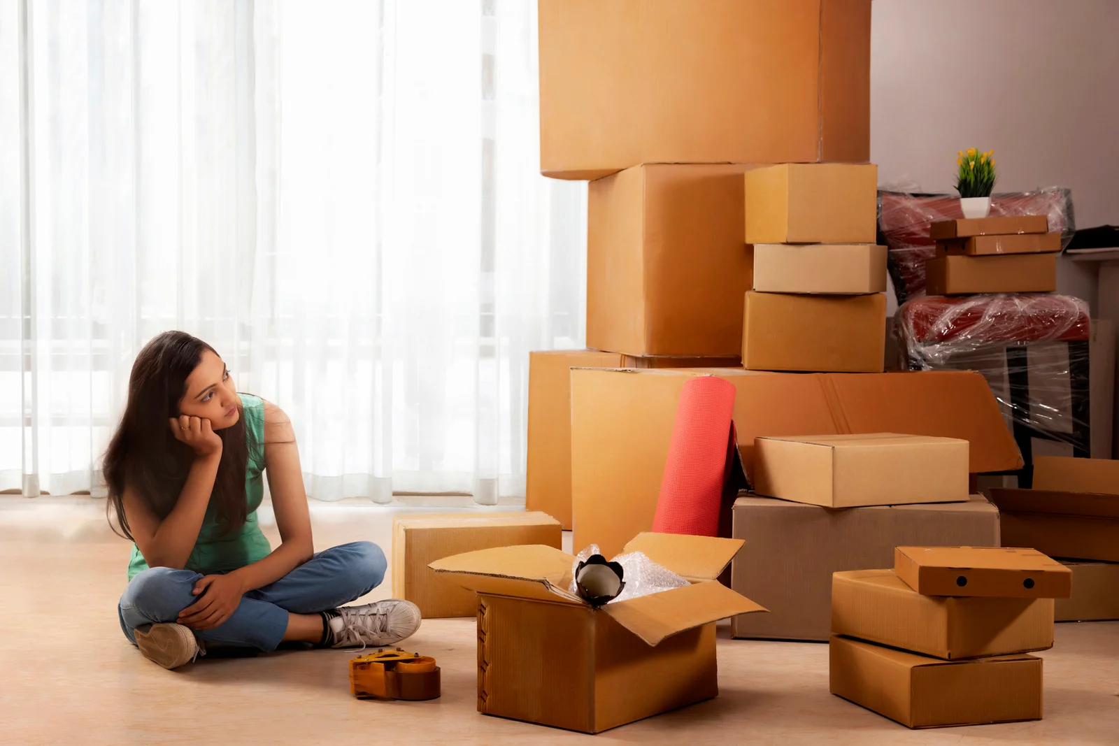 girls looking at carton box s stack while sitting on floor while moving 1767001220135