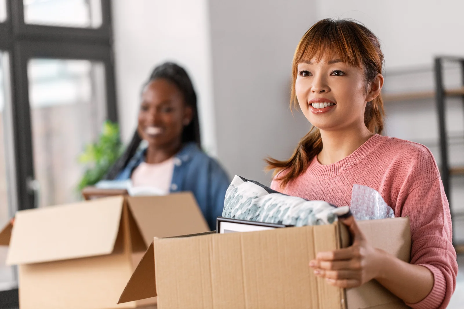 moving people and real estate concept happy smiling women with boxes at new home women with boxes moving to new home 1767001237018 moving people and real estate concept happy smiling women with boxes at new home women with boxes moving to new home 1767001237018