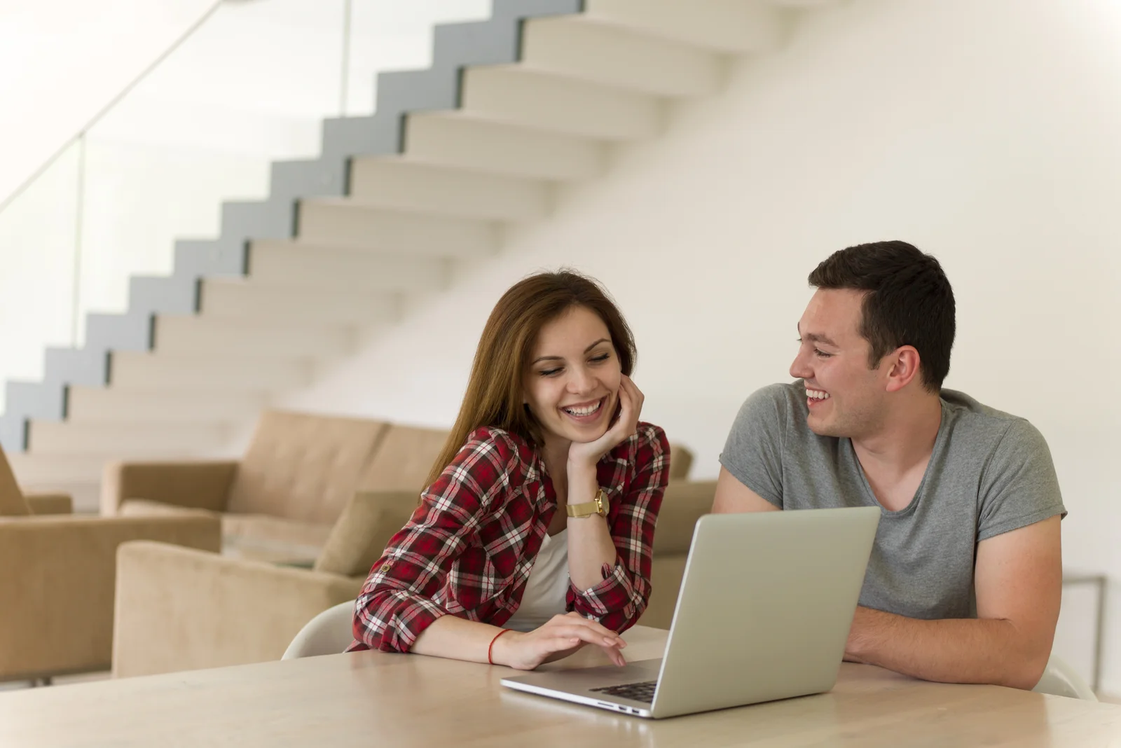happy-young-couple-buying-online-using-laptop-a-computer-and-a-credit-card-in-their-luxury-home-villa-1766999199017.webp