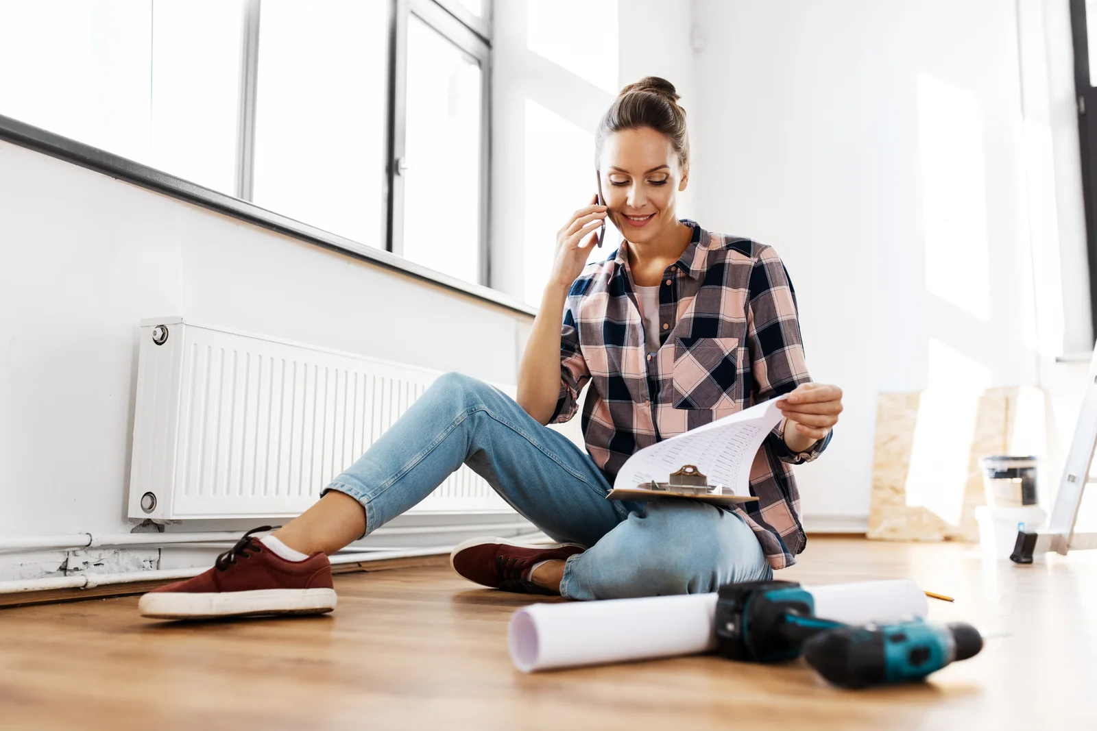 Woman on floor looking at plans